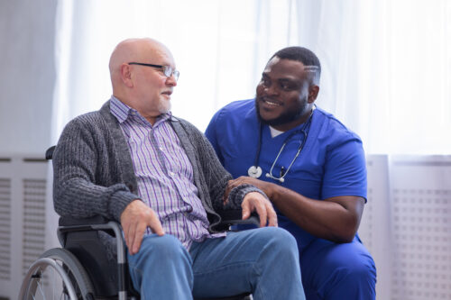 a man in a wheelchair talking to a doctor