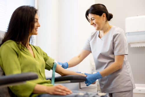 a nurse taking a blood sample from a patient
