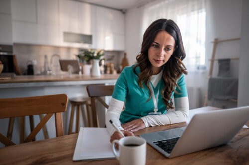 Person working on laptop at home.