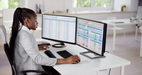 Person working at dual monitors