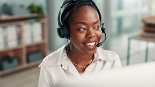 Office, call center and happy black woman on computer for contact us, crm service or customer support. Business, professional consultant and person with headset for communication, advice and feedback.
